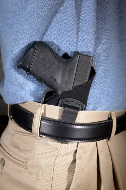 istock Man wearing a handgun in a clip on holster 945212824