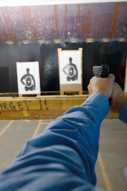 istock Man, possibly a police officer, on target practice 945213542