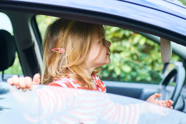 istock Little child girl playing inside car 945223180