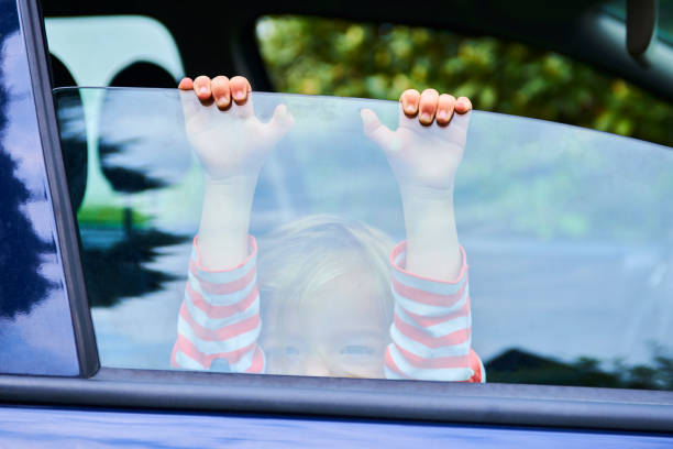 istock Little child girl playing inside car 945223228