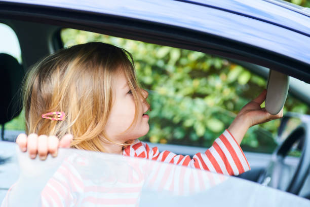 istock Little child girl playing inside car 945223230