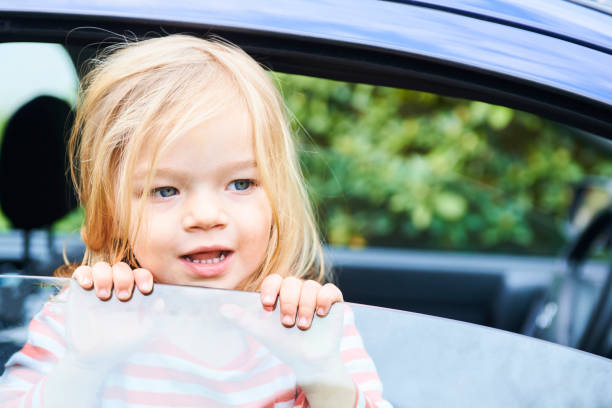 istock Little child girl playing inside car 945223236