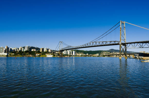 Bridge Hercilio Luz in Florianopolis Santa Catarina Brazil Bridge Hercilio Luz in Florianopolis Santa Catarina view from the mainland to the island, photo with sea and blue sky during the day. florianópolis stock pictures, royalty-free photos & images