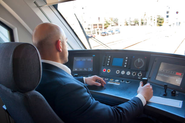 Train driver in cabin Portrait of handsome middle aged man driving the modern train in Europe transport conductor stock pictures, royalty-free photos & images