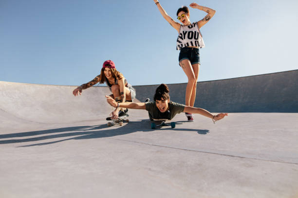 istock Group of women playing with skateboards 945244258