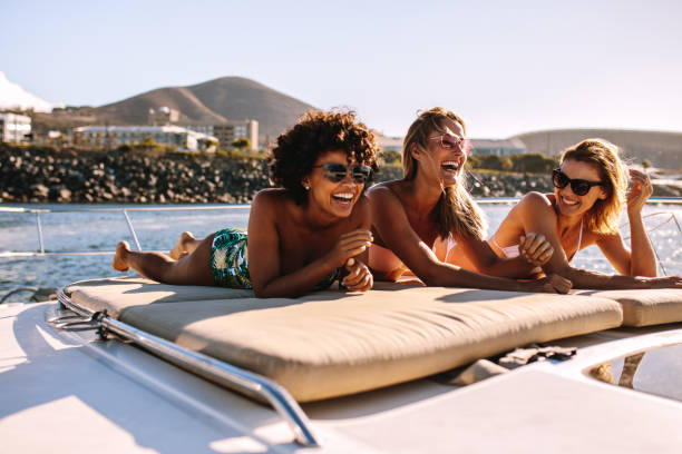istock Women friends relaxing on a private yacht deck 945244916