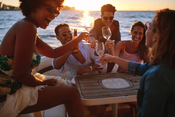 istock Smiling friends toasting at boat party 945247020