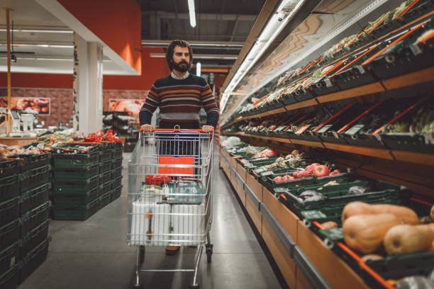 istock Handsome bearded man shopping in the supermarket 945248352