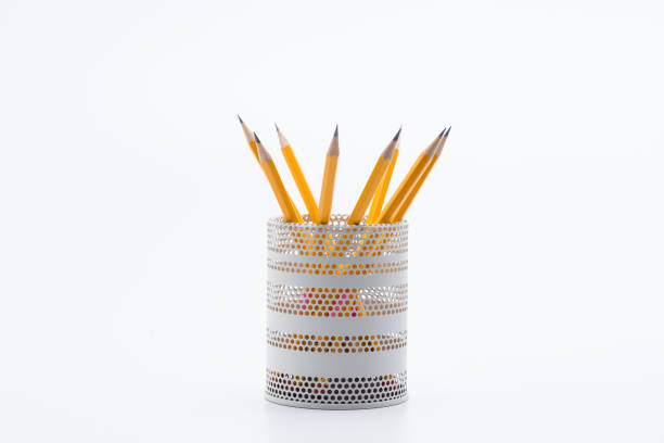 Yellow pencils in white metal pot on a white background