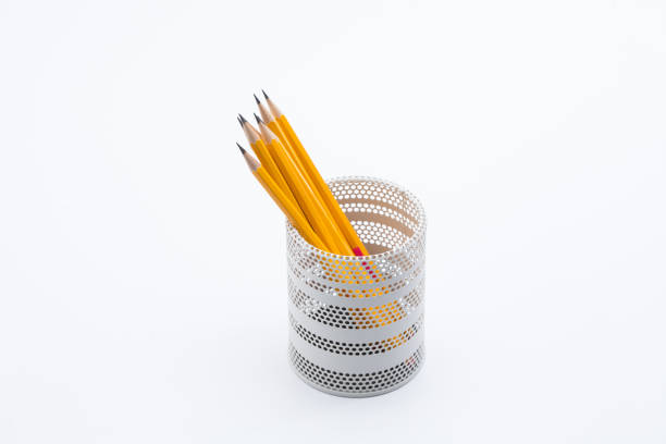 istock Yellow pencils in white metal pot on a white background 945258702