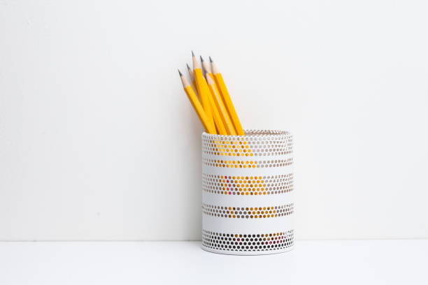 istock Yellow pencils in white metal pot on a white background 945258706