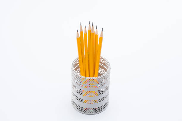 istock Yellow pencils in white metal pot on a white background 945258712