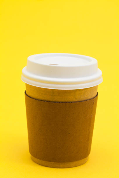 istock Take away coffee cup on the yellow background 945259348