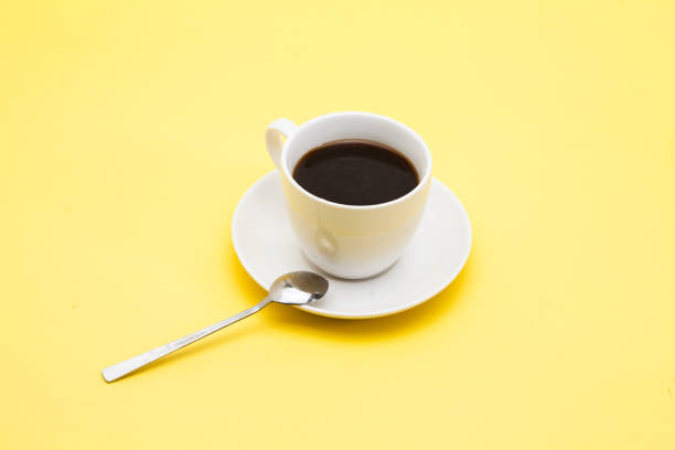 istock A cup of coffee on a yellow background 945259686