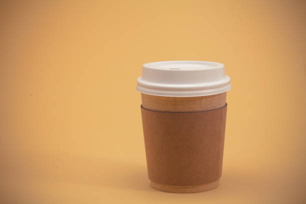 istock Take away coffee cup on the yellow background 945260422