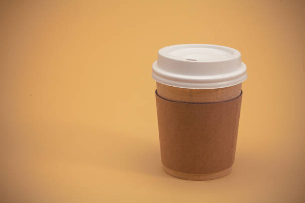 istock Take away coffee cup on the yellow background 945260424