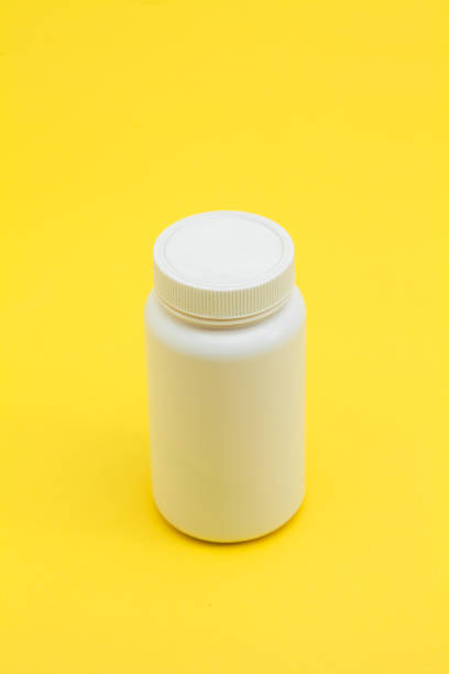 istock Medicine pils bottle on the yellow background 945260498