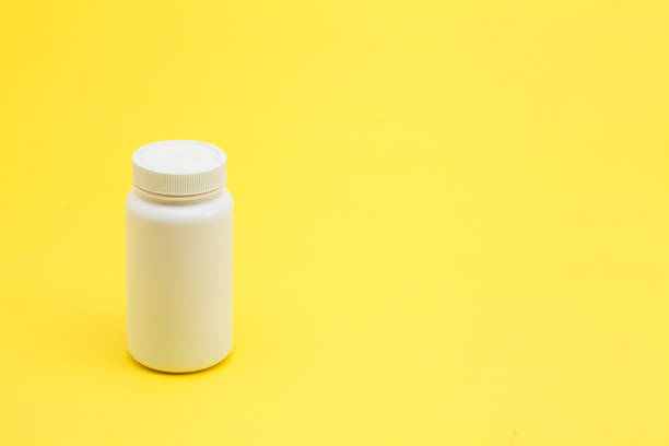 istock Medicine pils bottle on the yellow background 945260500