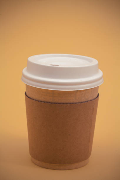 istock Take away coffee cup on the yellow background 945260540