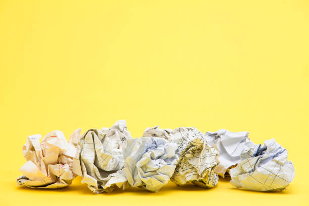 istock Crumpled papers on the yellow background 945260722