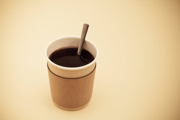istock Black coffee in a paper take away coffee cup with spoon 945260848
