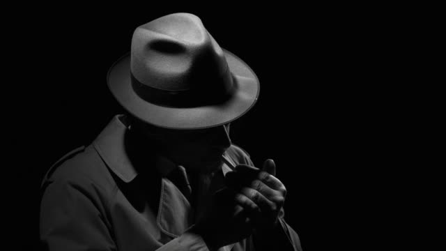 Noir detective smoking a cigarette in the dark