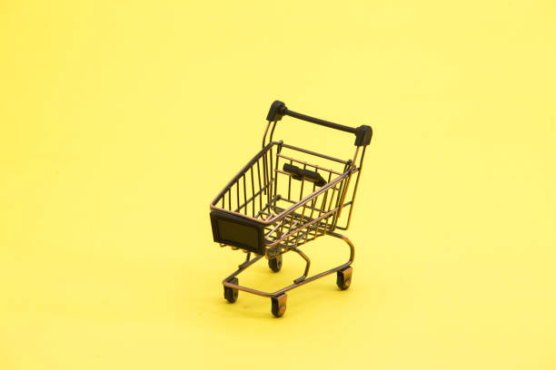 istock Brown shopping trolley cart on yellow 945263796