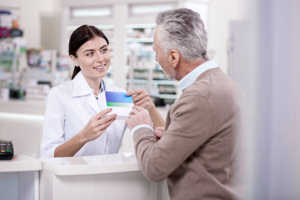 istock Jolly female pharmacist selling drug 945270890