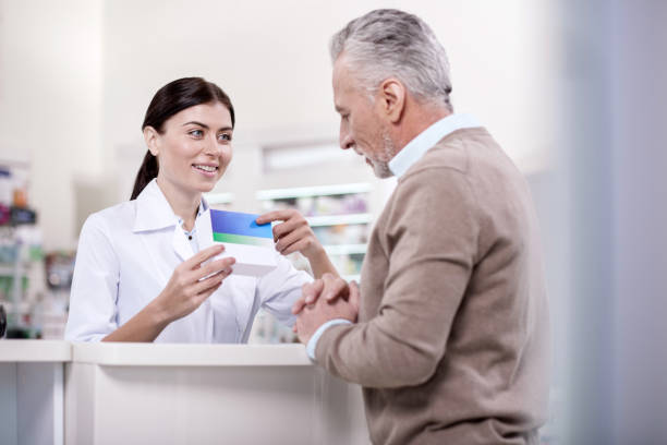 Pleasant female pharmacist proposing drug