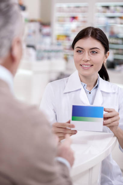 istock Appealing female pharmacist warning about reaction 945270956