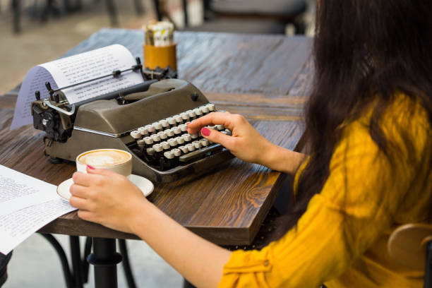 istock Cropped shot of a writer's hands typing on retro typewriter 945273798