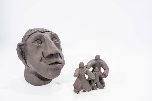 Happy family concept. Figures made from play clay.  Family under the big glass dome.