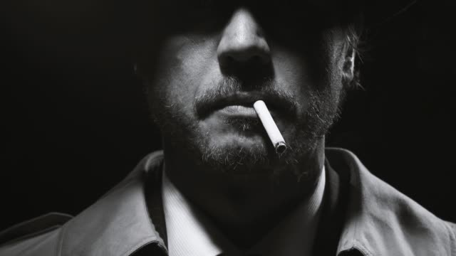 Portrait of a retro noir detective smoking a cigarette
