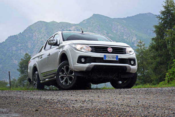 Fiat Fullback in mountain scenery Torino, Italy - June 18th, 2016: Fiat Fullback stopped on the road in mountain scenery. This model is the biggest pick-up vehicle in Fiat offer in Europe. The Fullback based on Mitsubishi L200. truck in rain stock pictures, royalty-free photos & images