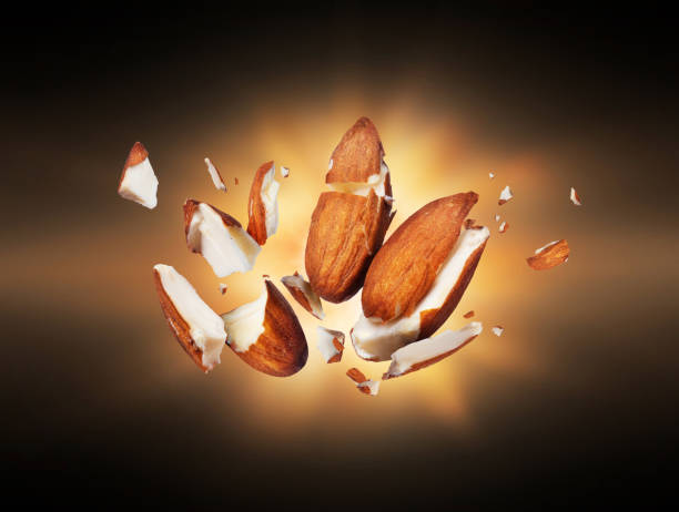 Almonds is torn to pieces close-up in the dark Almonds is torn to pieces close-up in the dark almond slivers stock pictures, royalty-free photos & images