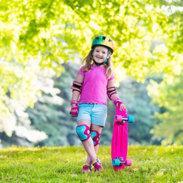 Child riding skateboard in summer park Child riding skateboard in summer park. Little girl learning to ride skate board. Active outdoor sport for school and kindergarten kids. Children skateboarding. Preschooler on longboard. Kid skating. 15495 stock pictures, royalty-free photos & images