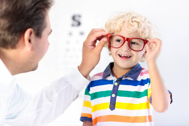 istock Child at eye sight test. Kid at optitian. Eyewear for kids. 945296598