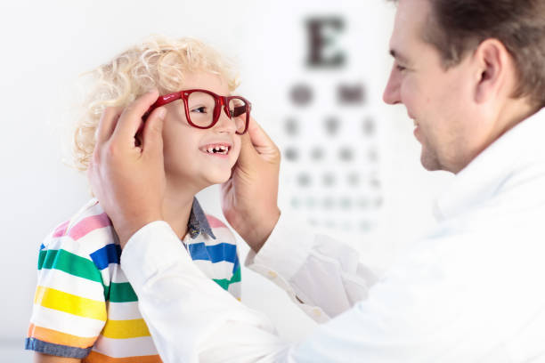istock Child at eye sight test. Kid at optitian. Eyewear for kids. 945296770