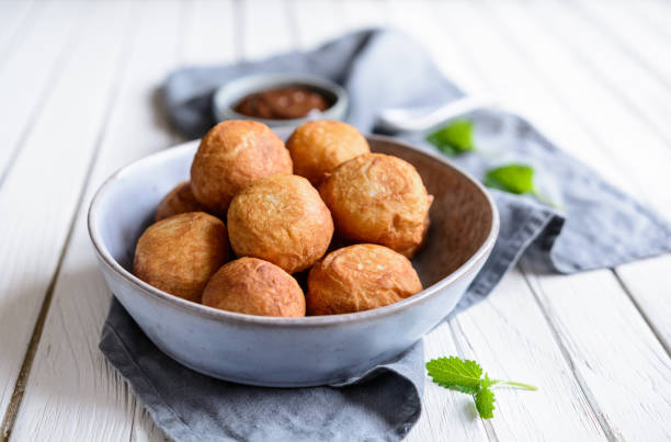 istock Bunuelos - traditional Colombian deep fried pastry with chocolate sauce 945297198