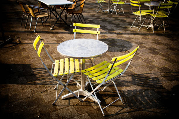 istock three yellow chairs around an outdoor bistro table 945300530