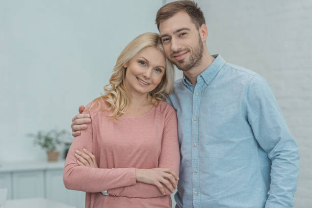 istock portrait of smiling son hugging mother and looking at camera 945304562