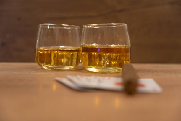 istock Royal flush, whiskey with ice and cigar. 945308902