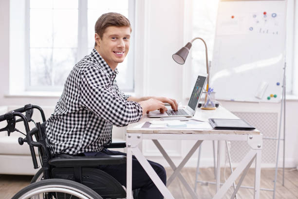istock Handsome paralyzed man enjoying his job 945309028