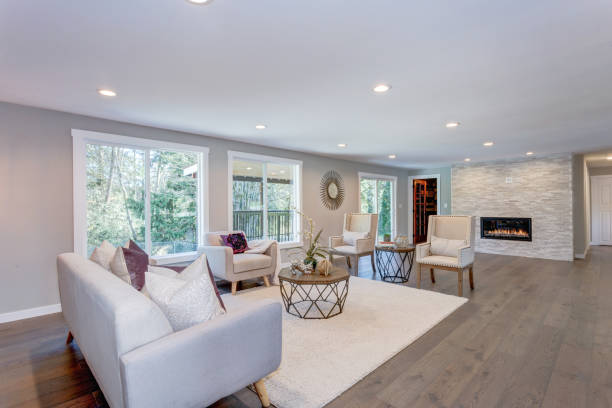 istock Spacious white living area with stone fireplace 945312944