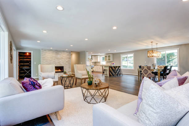 istock Spacious white living area with stone fireplace 945317018