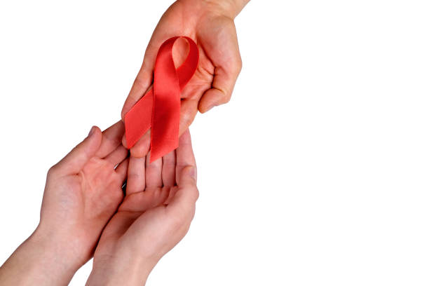 istock A female hand passes a red ribbon. 945326894