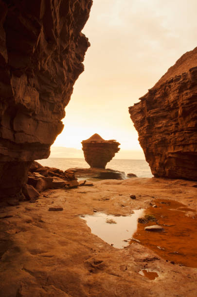 istock Red sandstone pillars on the Atlantic ocean 945330206