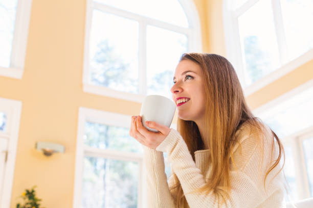 istock Happy young woman drinking coffee 945343874