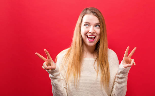 istock Young woman giving the peace sign 945343884