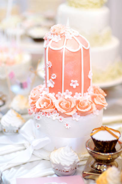 istock Pink wedding cake decorated with sugar flowers 945343888